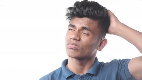 Young Adult Male Thinking and Scratching His Head
