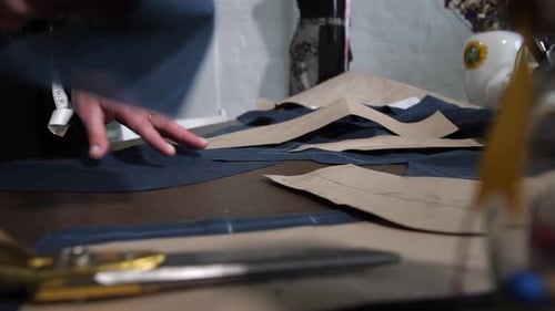 Tailor Smoothing Dark Fabric in Bright Studio