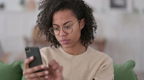 Woman Using Mobile Phone Indoors