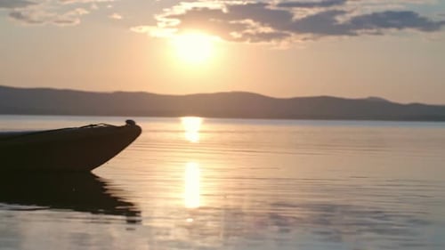 Man Kayaking Over Ocean Waters at Sunset