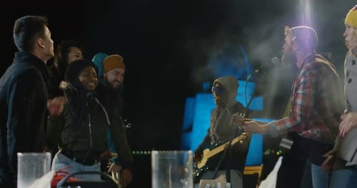 Band Performing Live Music at Night with Friends