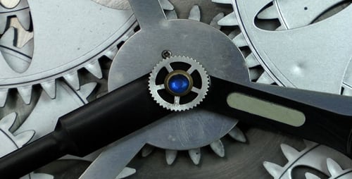 Silver Clock Gears Turning Smoothly in Close Up