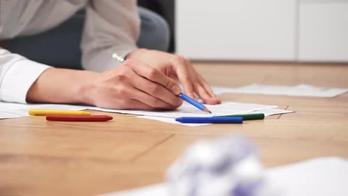 Girl Sits On The Floor And Fills Out Papers. Hands Write On Paper. Close Up Girl Writing A Text