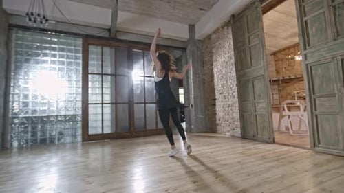 Energetic Woman Dancing in a Bright Studio