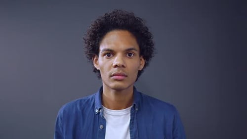 Adult with Curly Hair Stares at Camera