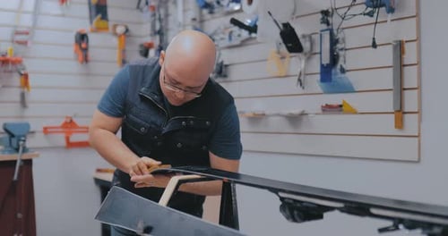 Brutal Man Master Prepares Skis Polishes Wax with a Brush