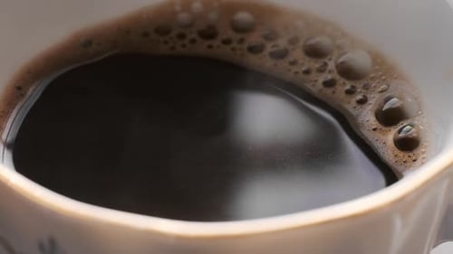 Close Up of Steaming Coffee in a Cup