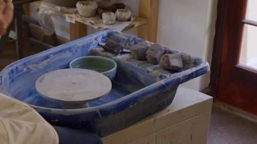 Young female potter working in her studio