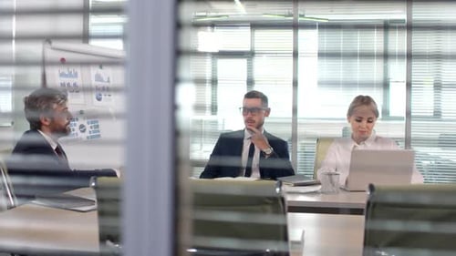 Business Meeting in Modern Office with Glass Walls
