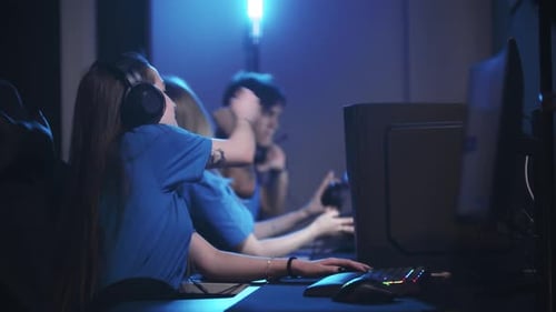 Group of Friends Sitting in the Gaming Club and Having an Online Tournament Winning the Game and