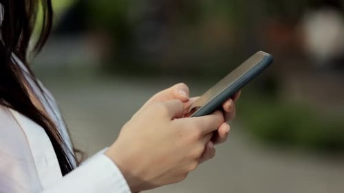 Close Up of Hands Using Smartphone Device
