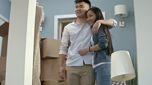Happy Couple Hugging in New House