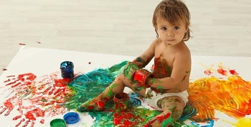 Toddler Covered in Colorful Paint is Making Art