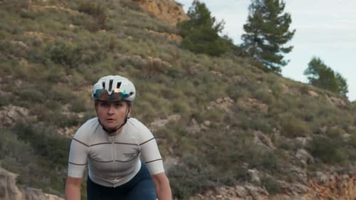 Strong Woman Pro Cyclist on Hard Road Training