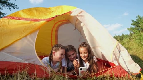Teenage Girls Resting in a Tent Camping for Children in the Woods