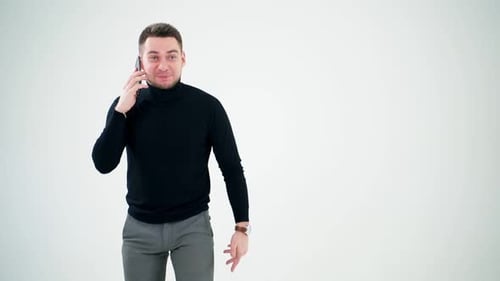 Man Talking on Smartphone in Studio Setting
