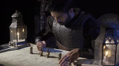 Man Plots Strategy by Candle Light