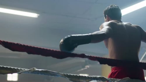 Man Practices Boxing Punches in Boxing Ring