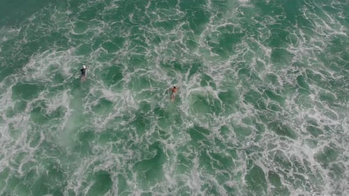 Aerial View of Surfers Paddling in the Ocean