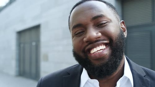 Businessman Looking at Camera on City Street. Male Executive Standing on Street