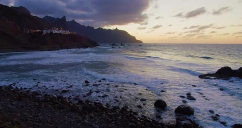 Coastal Waves Crashing on Rocky Shore at Sunset