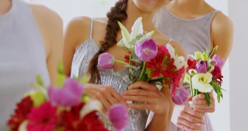 Happy bridesmaids in grey dresses holding flowers 4K 4k