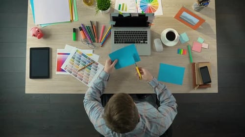 Interior Decorator Cutting Colored Paper, Making Colorful Party Decorations
