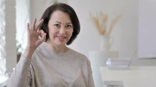 Woman Smiling and Giving Okay Hand Sign