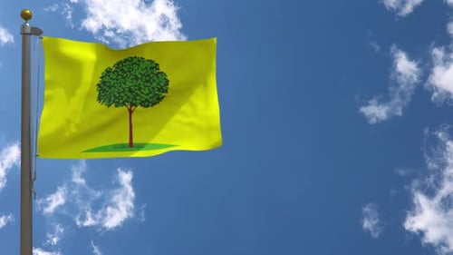 Yellow Flag with Green Tree Waving in Blue Sky