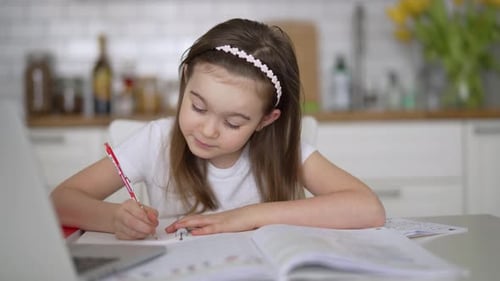 Girl Doing Homework at Kitchen Table