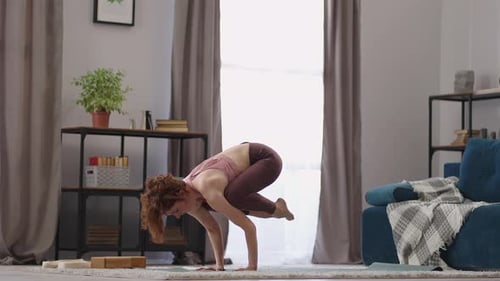 Sporty Strong Woman is Doing Handstand Practicing Yoga in Apartment Performing Asana for Balance and