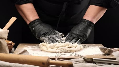 Baker Kneading Dough on a Cutting Board