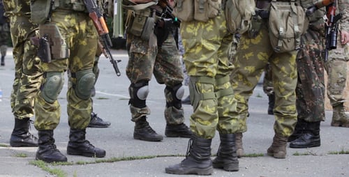 Soldiers in Camouflage with Weapons Standing in Formation