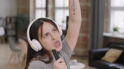 Woman with Headphones Sings into Comb Microphone
