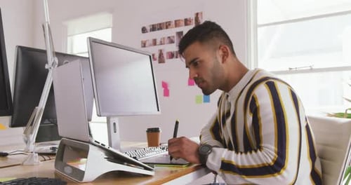 Mixed race man working in creative office