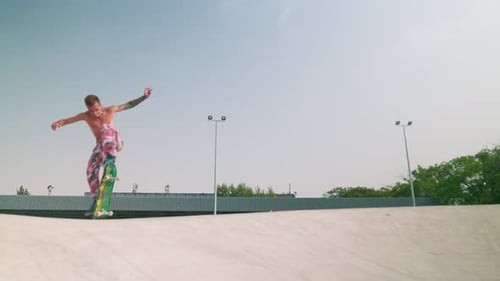 Skateboarder Does Flip Trick at Skatepark