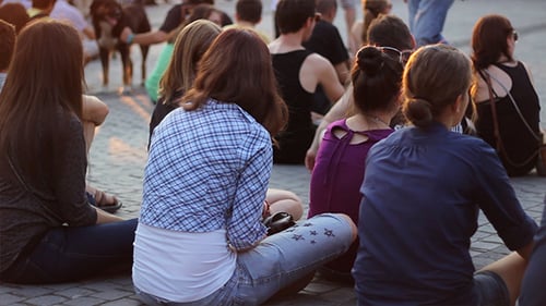 Girls Audience Sitting on Pavement