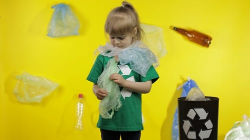 Girl Activist Free Up From Plastic Packages on Her Neck and Head. Plastic Pollution. Save Ecology