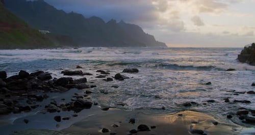 Long Waves Rise in Air in Beautiful Sunset Light and Sunbeams at Benijo Beach in Tenerife Canary