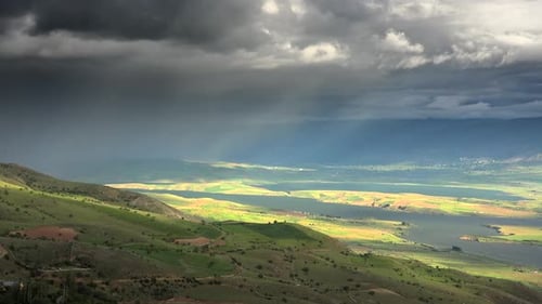 Storm Clouds and Rain Approaching to Lake Geography Surrounded by Hilly Moorland