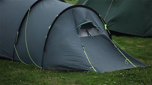 Camping Tent Set Up on Grassy Field