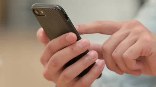 Hand Browsing on Smartphone Close Up