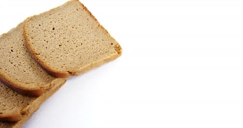 Slices of Brown Bread on White Background