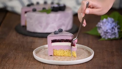 Delicious Blueberry Mousse Cake Slice Being Eaten