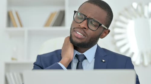 Adult With Neck Pain At Work Massaging Neck