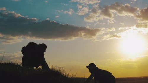 Friends Climb Hill at Golden Sunrise