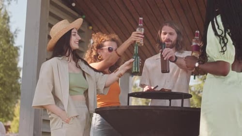 Young Adults Toasting at Summer Backyard Barbecue