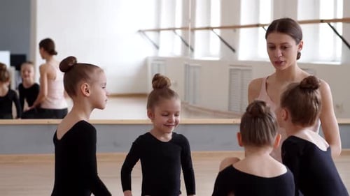 Teacher Communicating with Ballerinas in Ballet School