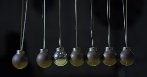 Swinging Pendulum with Spherical Weights in Motion