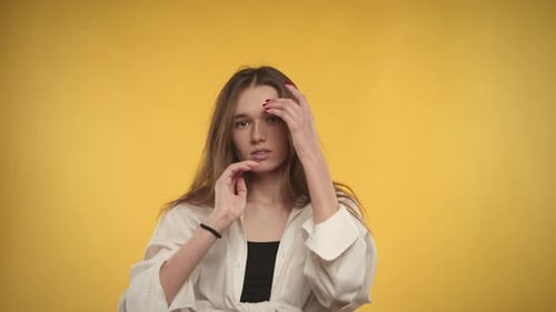 Woman Posing with Style on Yellow Background